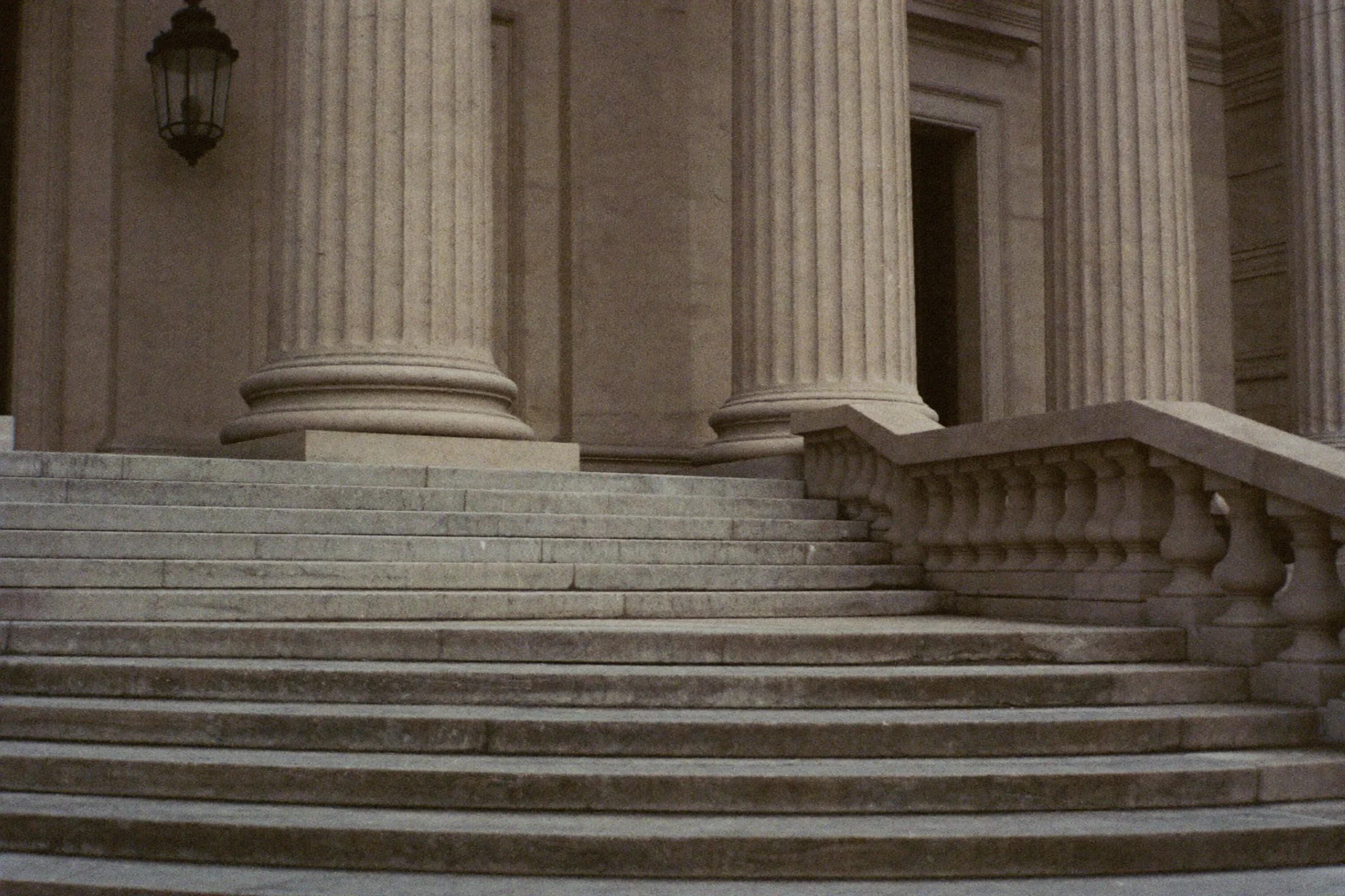 Courthouse columns and steps under an overcast sky
