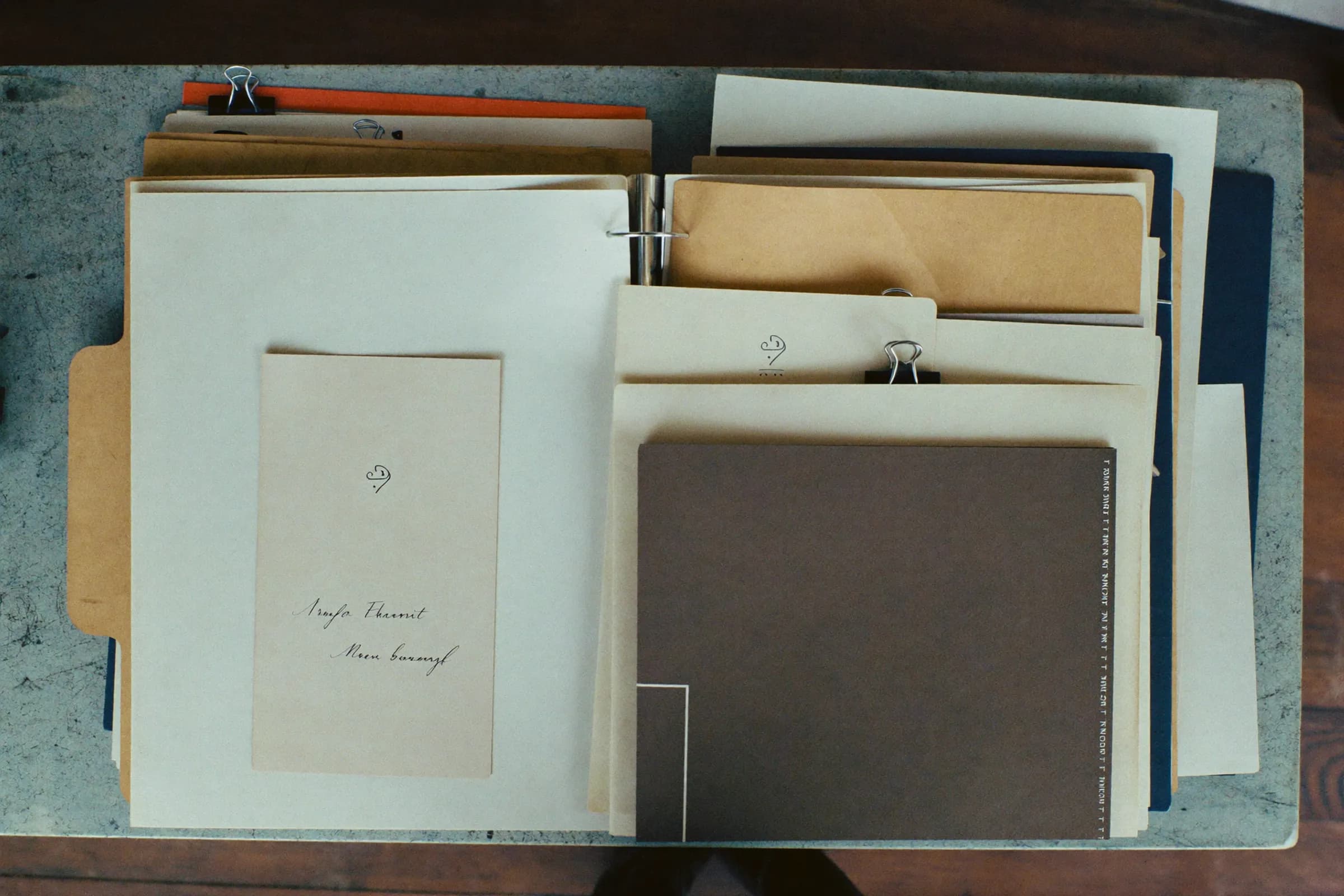 Bound documents and folders on a stone desk