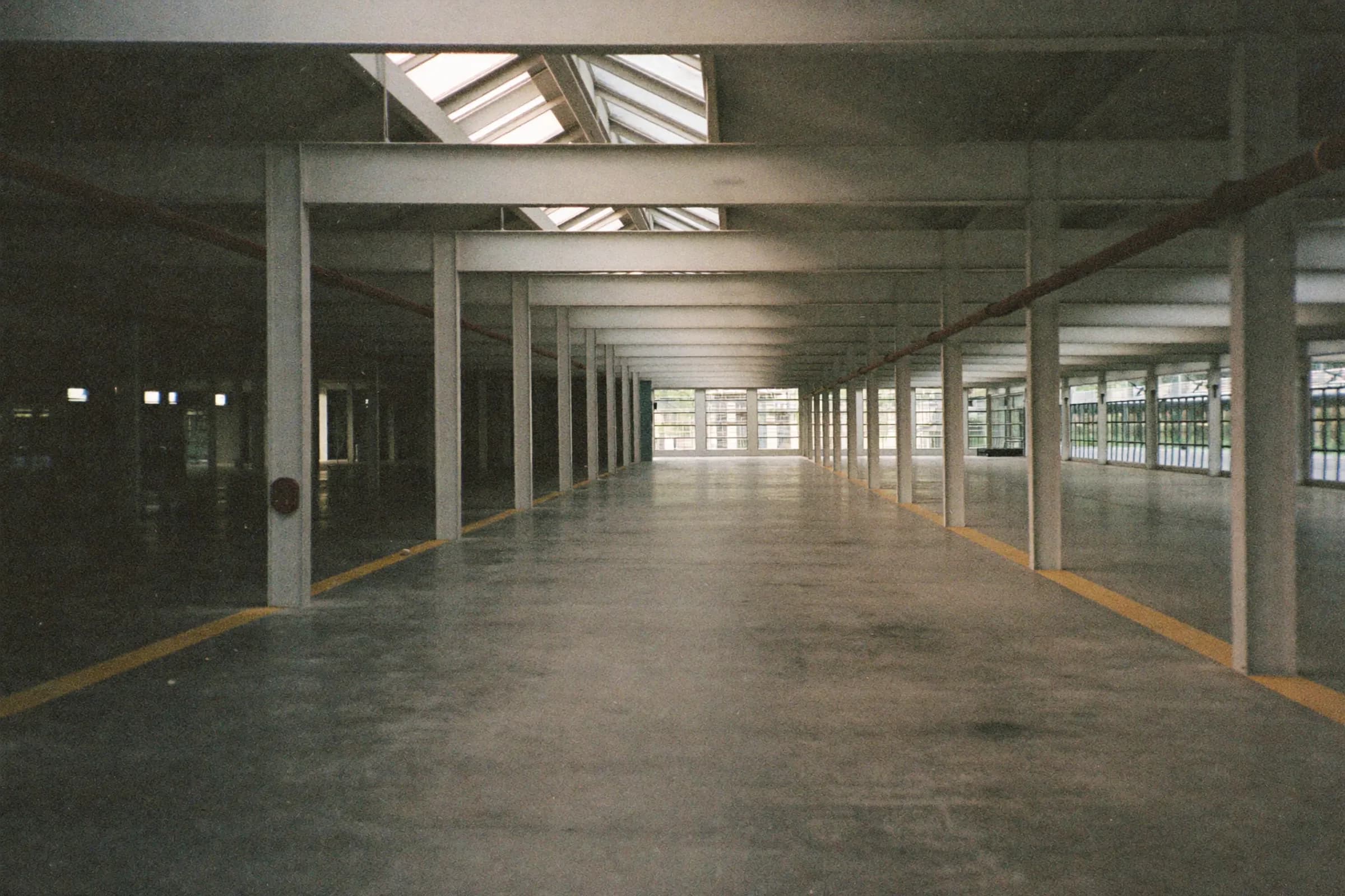 An empty industrial floor under skylights