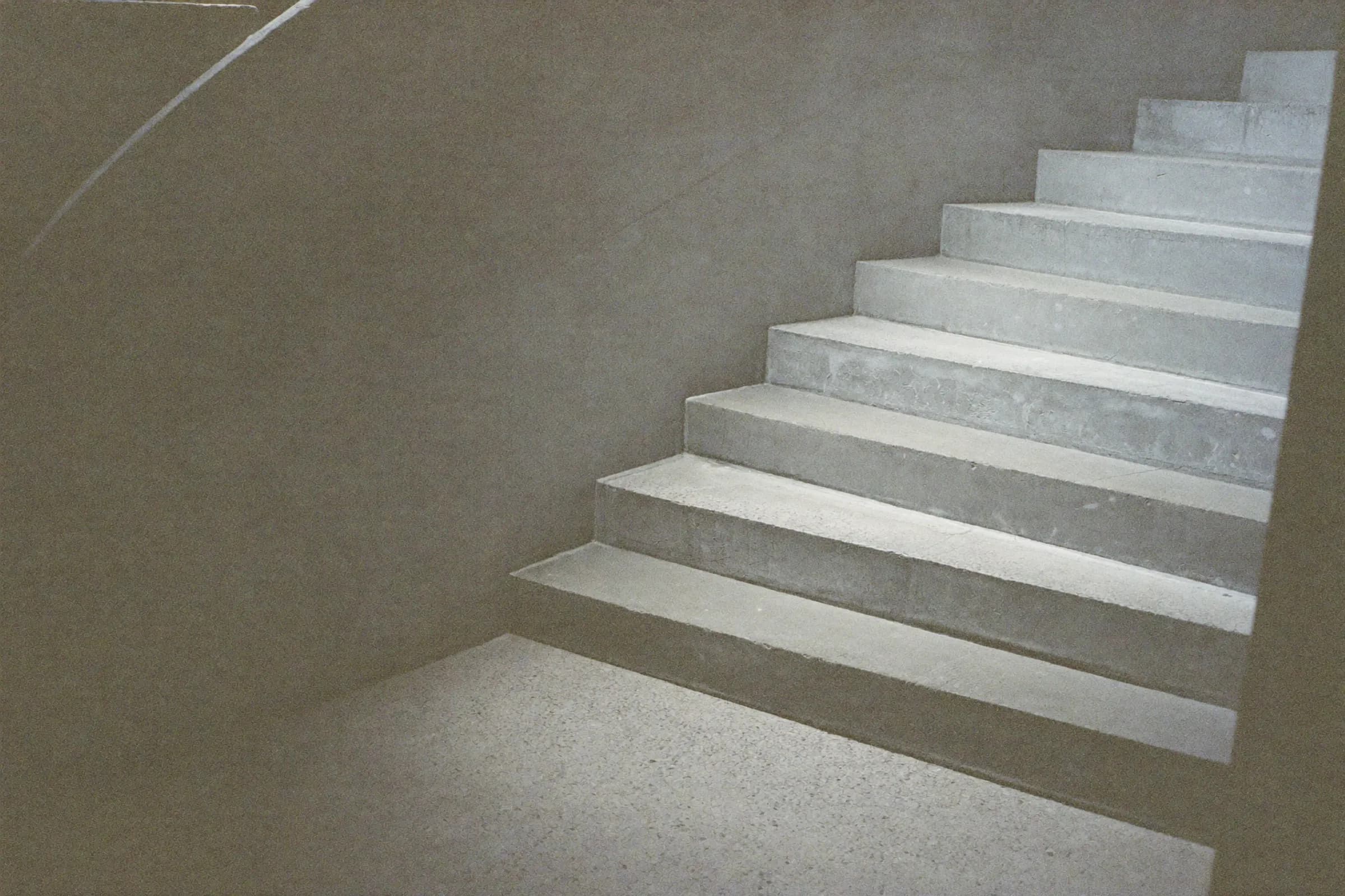 A concrete staircase rising through soft light