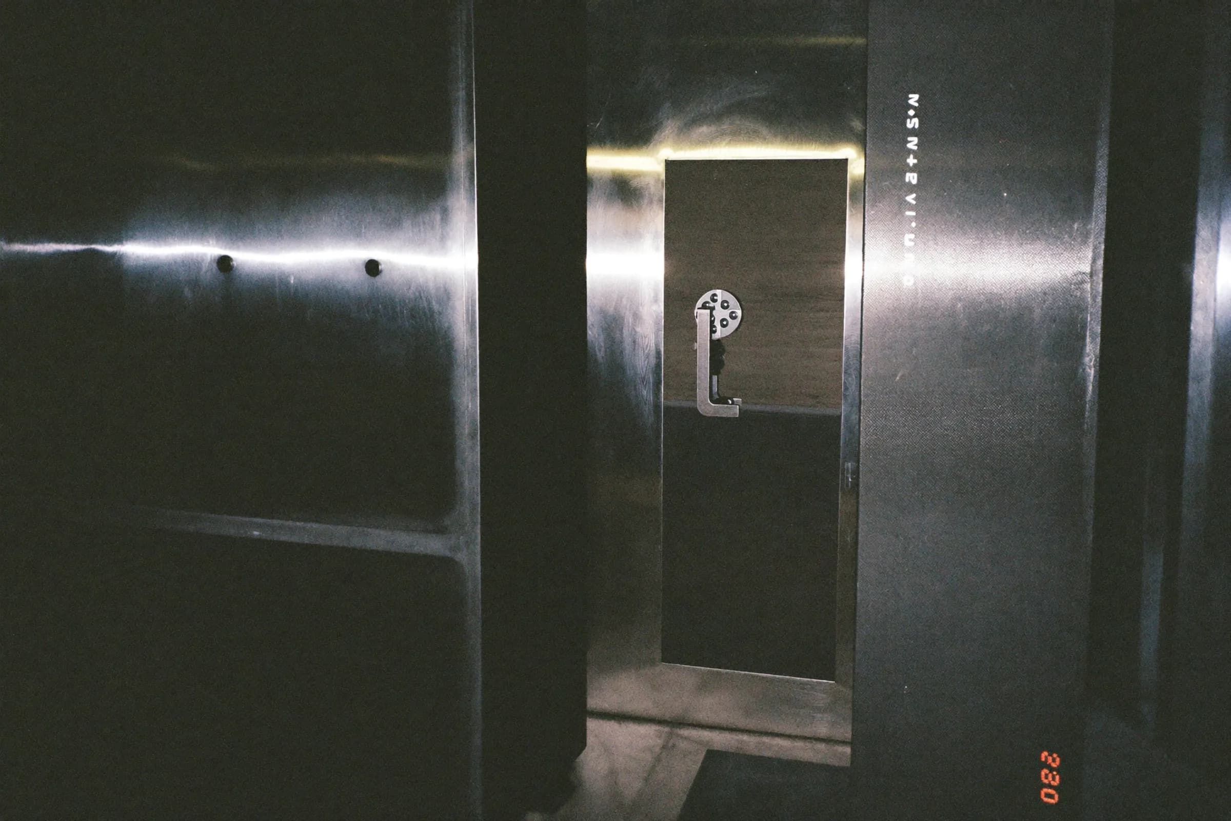 A heavy steel vault door, partly open